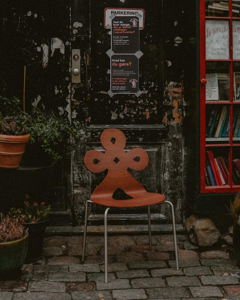 Connie's chair in a stone-brick alley, in front of a bookstore.