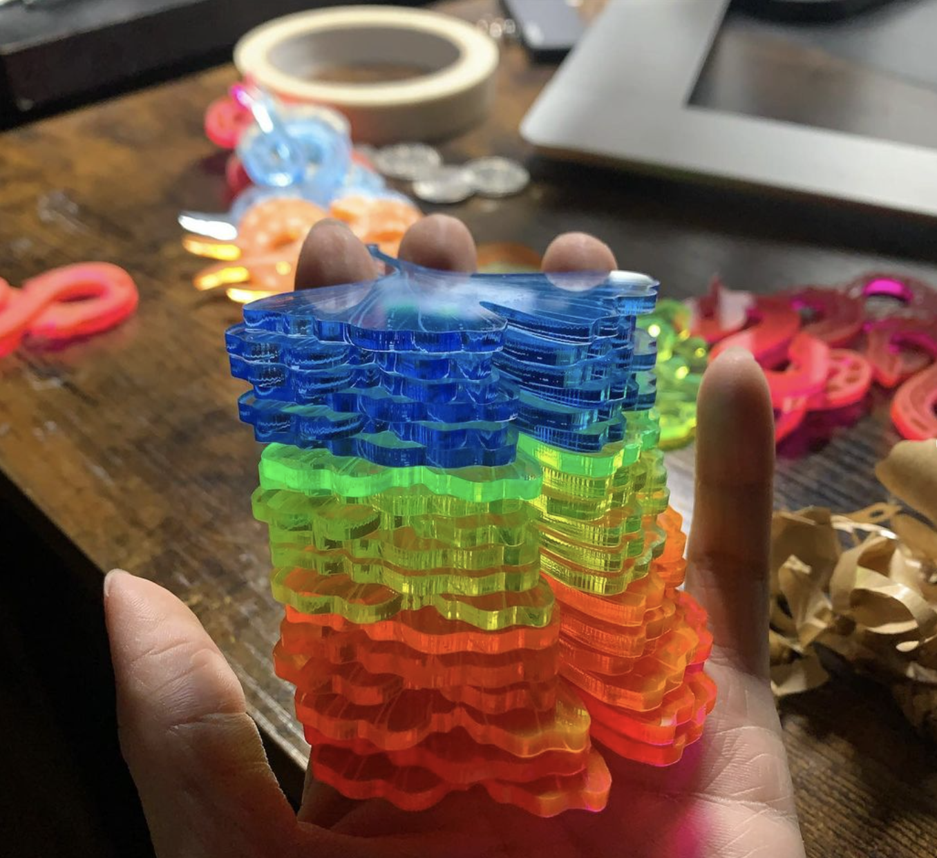 Multicolored Ginkgo-leaf-inspired acrylic earrings that were lasercut by Connie.